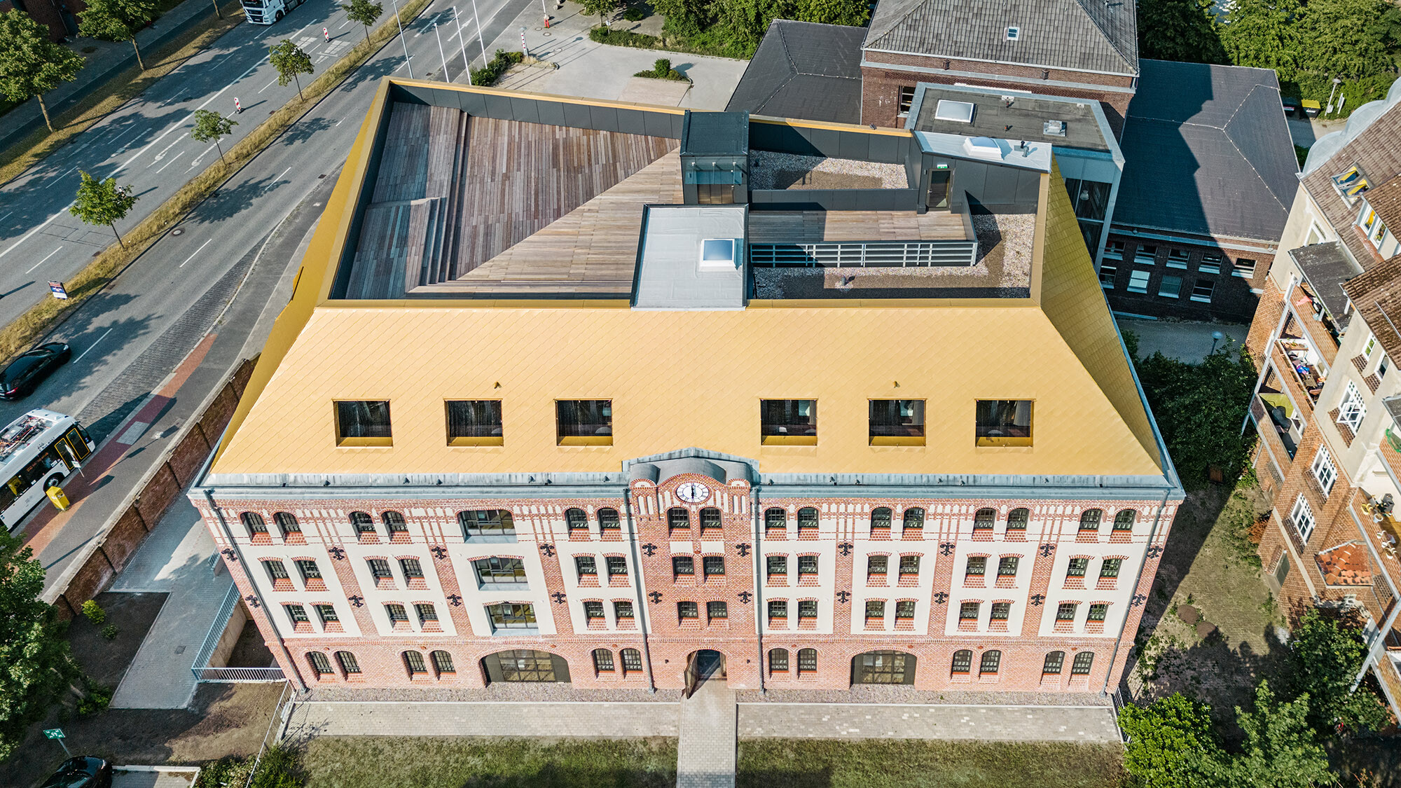 The house from a bird's eye view; the roof terrace, the new roof as well as the historic façade and built environment are in view.