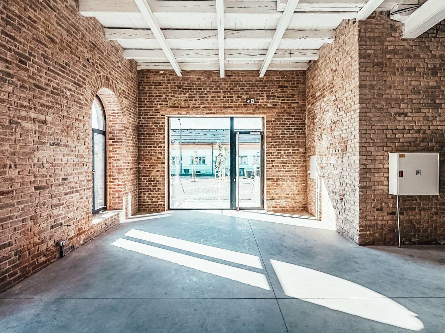 Inside view of the enamel facory. The walls are made of bricks. The sun is shining through the windows.