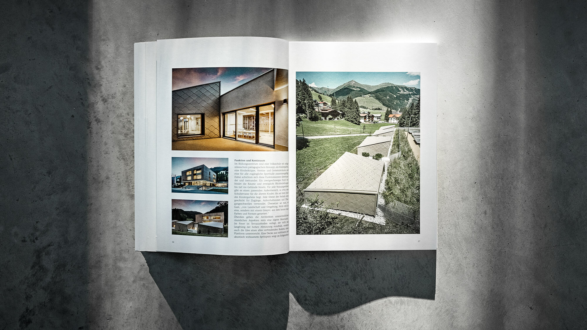The open PREFARENZEN book 2024 with an article on the Gerlos education centre by UNISONO ARCHITEKTEN before a grey background.