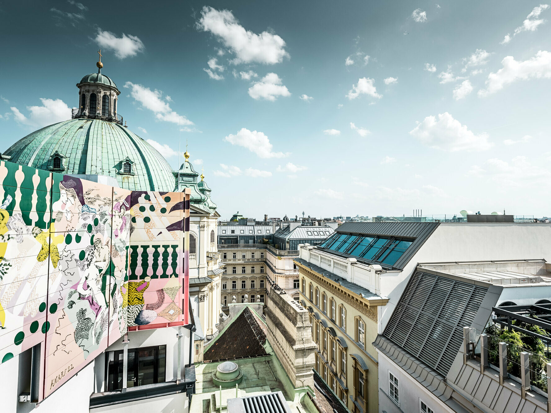 View of the surrounding area from the roof: Part of the Peter's Church and several residential buildings can be seen.