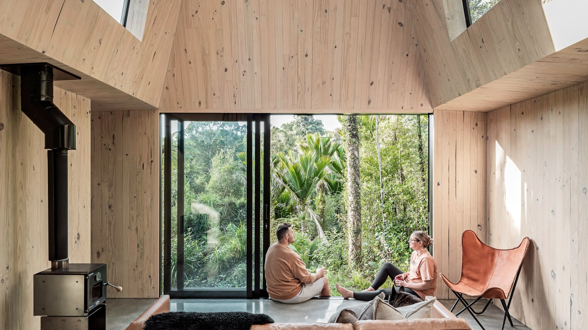 The building from the inside, two people are sitting by the open sliding door.