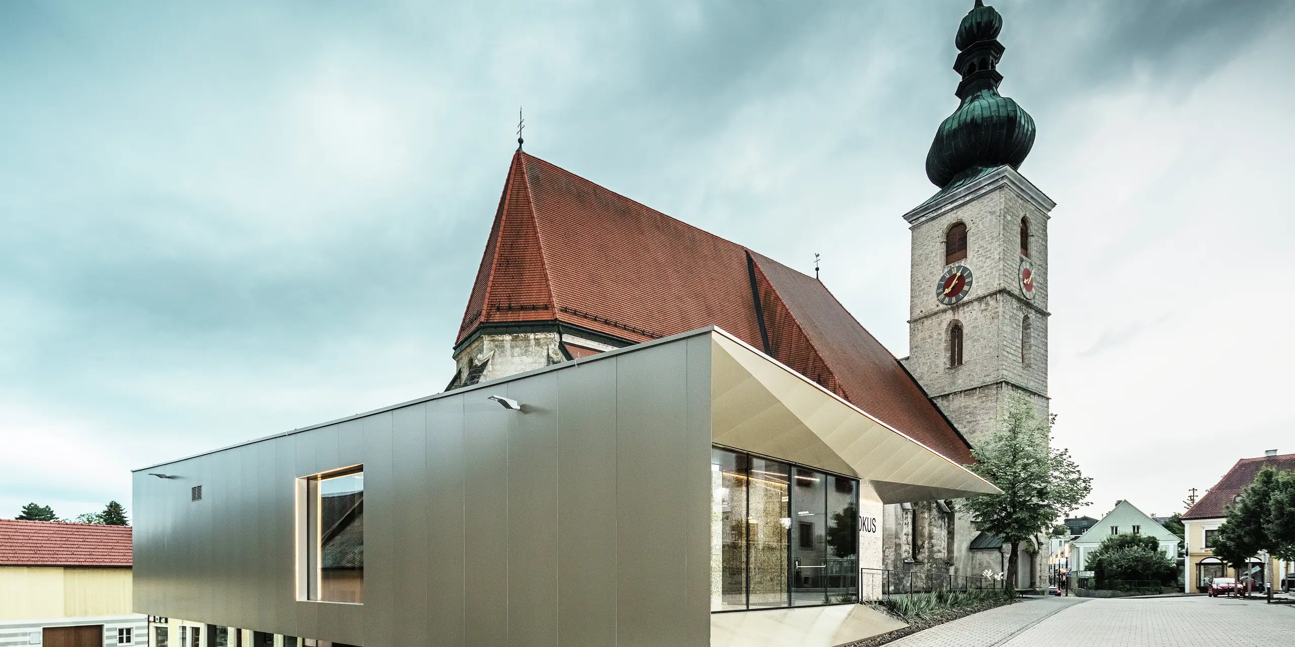 The side view shows the delicate roof overhang, created using high-quality PREFA aluminium composite panels. The precise workmanship creates a modern look with clean lines and emphasises the architectural connection between old and new.