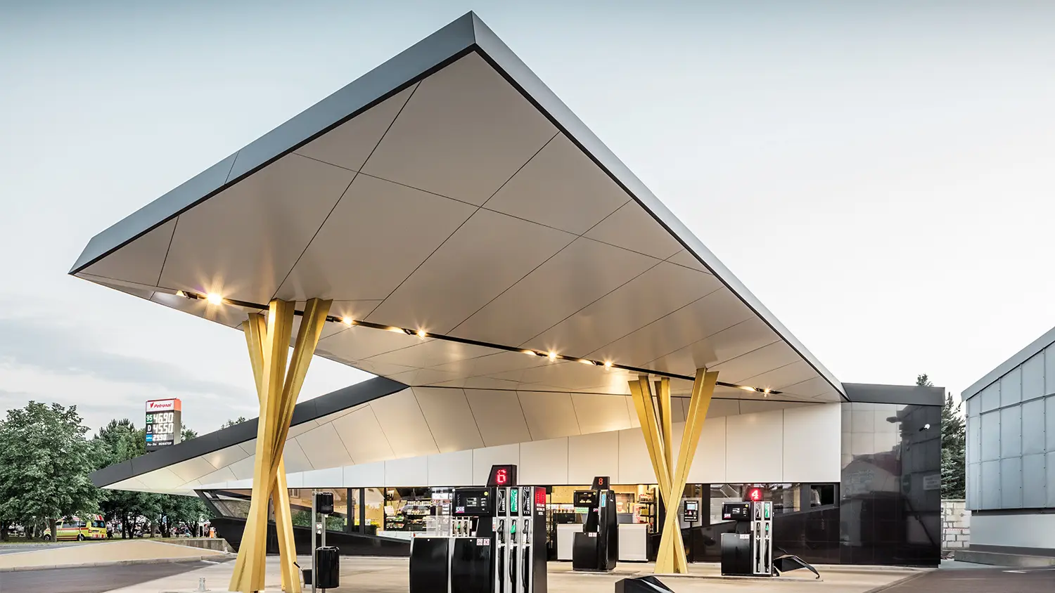 Another side view of the petrol station with the bottom side of the roof and the group of supports in view.