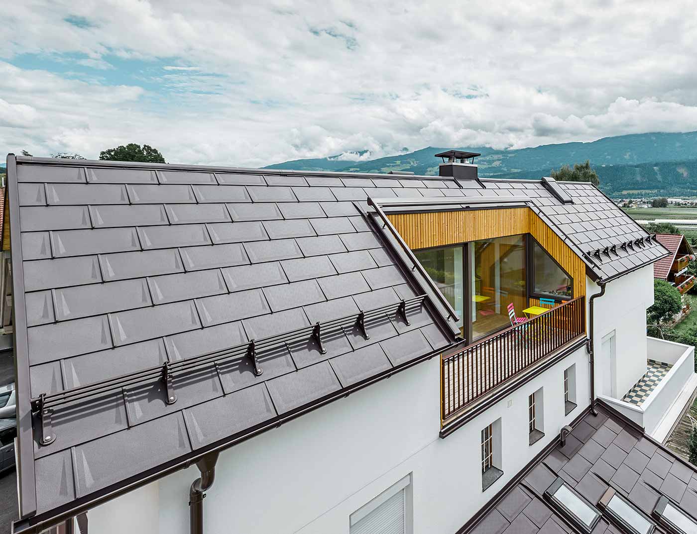 PREFA R.16 roof tile nut brown reference House divided into flats with generous loggia - the roof is covered with PREFA R.16 roof tiles in nut brown.